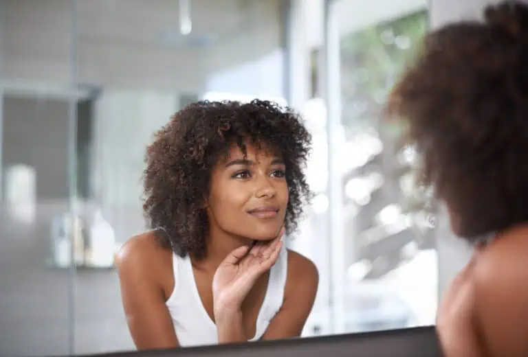 a woman looking at herself in a mirror