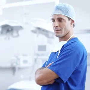 a man in a blue scrubs and a blue hat