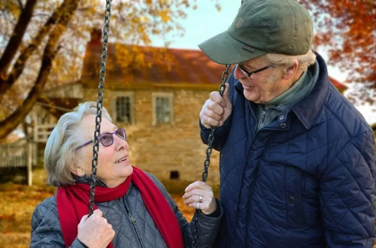 a man and woman on a swing