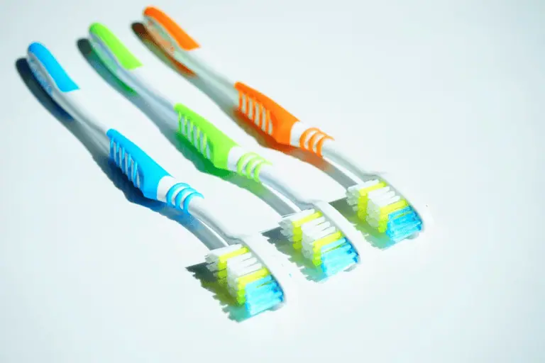 a group of toothbrushes on a white surface