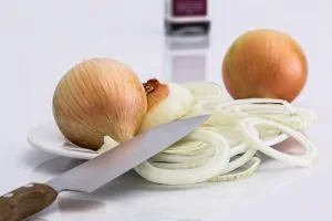 a knife and onions on a plate