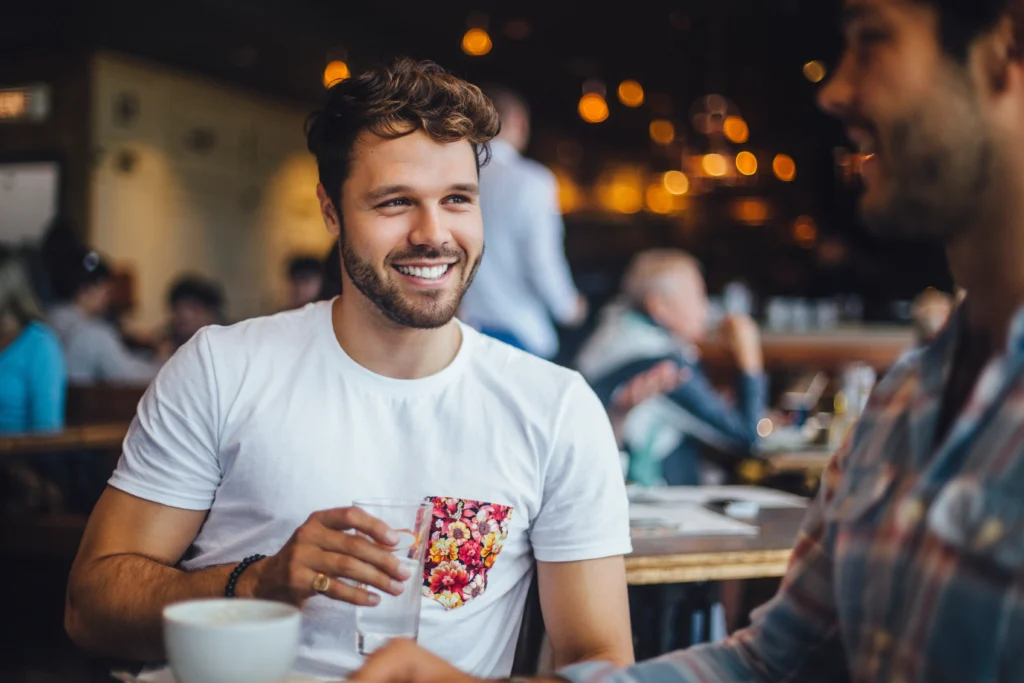 a man smiling at another man