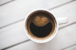 a cup of coffee with a smiley face