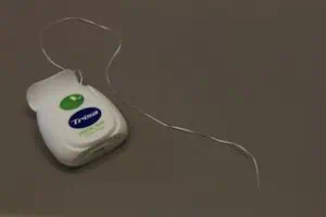 a dental floss on a gray surface