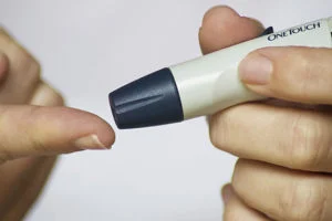 a close-up of a person using a lancet