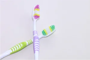 a couple of toothbrushes on a white background