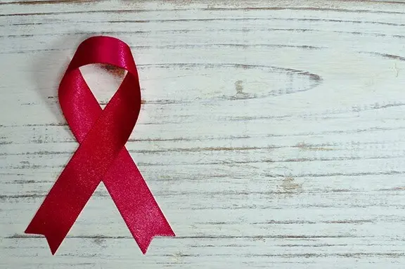 a red ribbon on a white surface