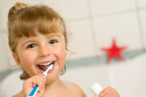 a young girl brushing her teeth