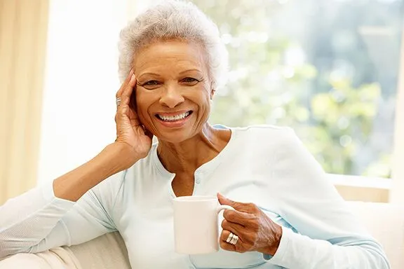 a woman holding a cup