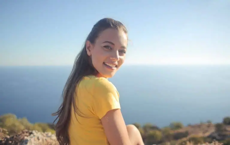 a woman sitting on a hill