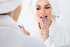 a woman brushing her teeth