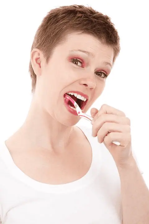 a woman brushing her teeth