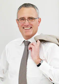 a man wearing glasses and a tie