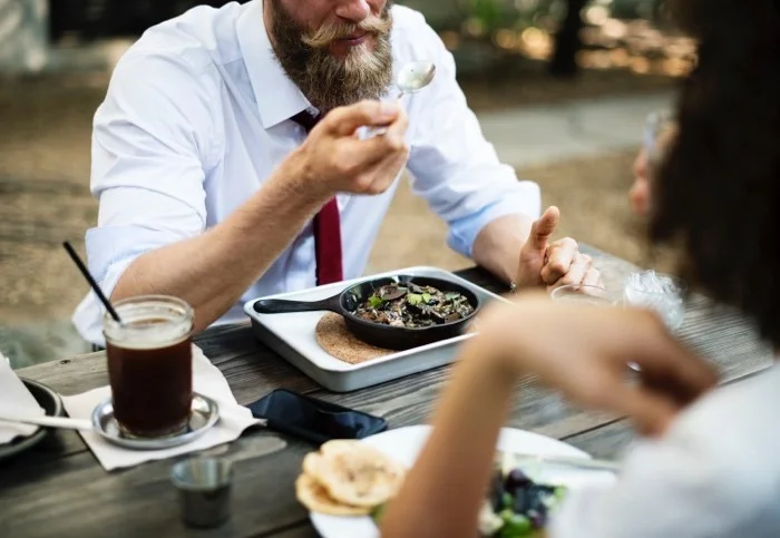 a man eating food at a table