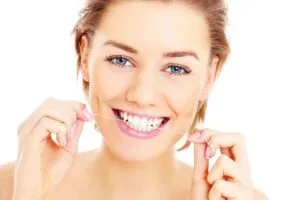 a woman flossing her teeth