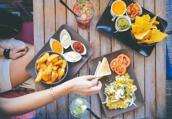 a person eating food on plates