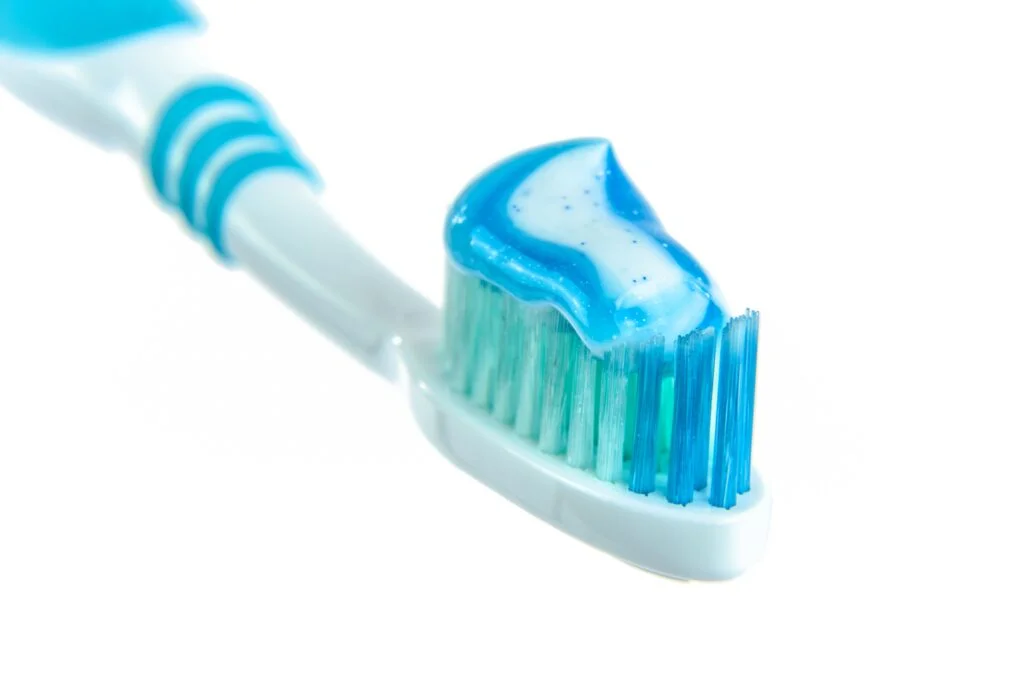 a toothbrush with blue toothpaste on it