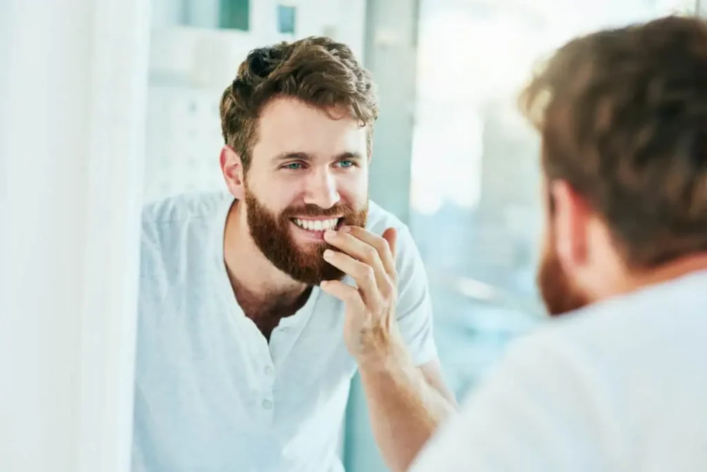 a man touching his beard