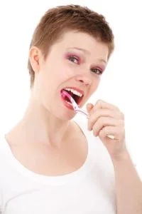 a woman brushing her teeth