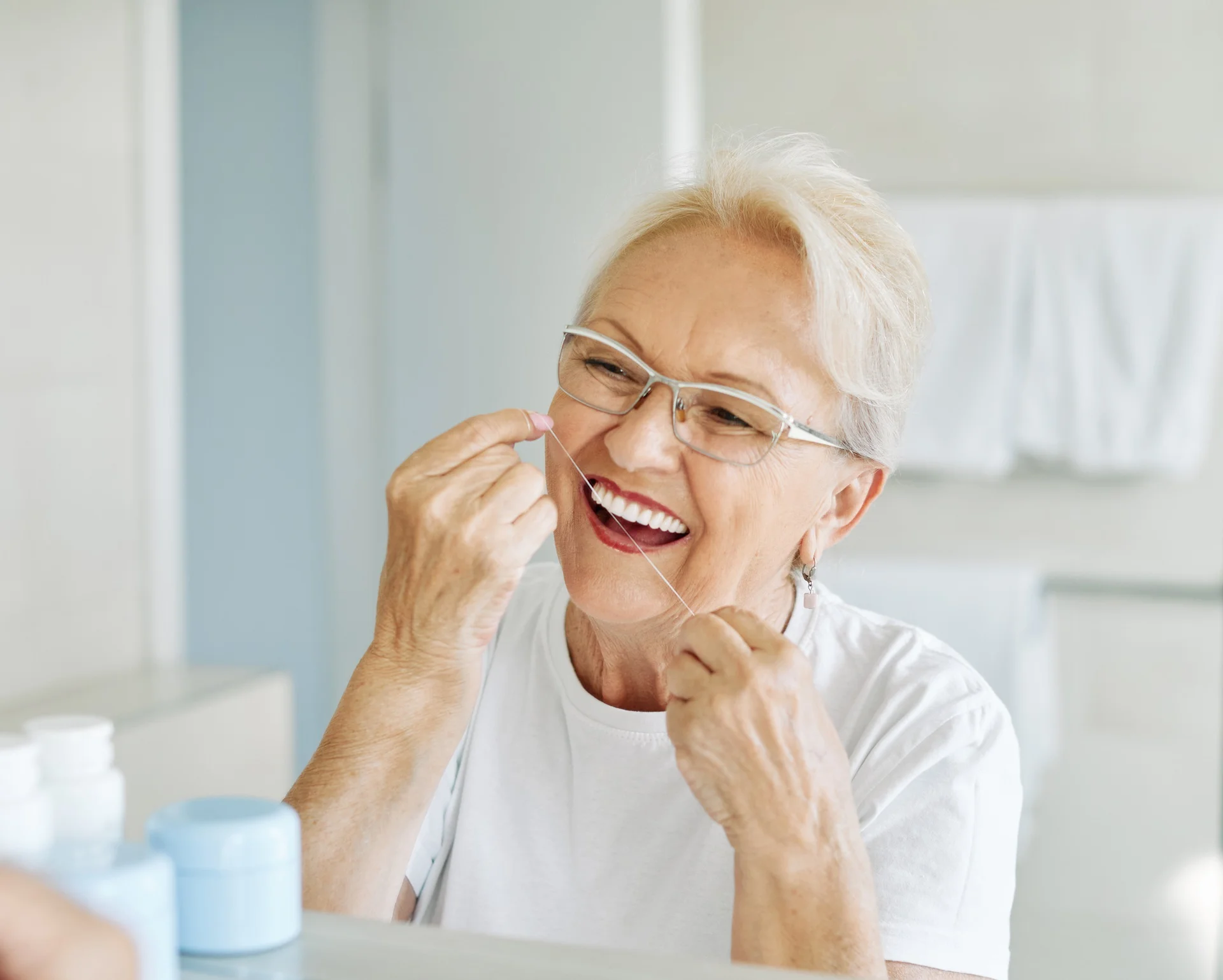 a woman flossing her teeth