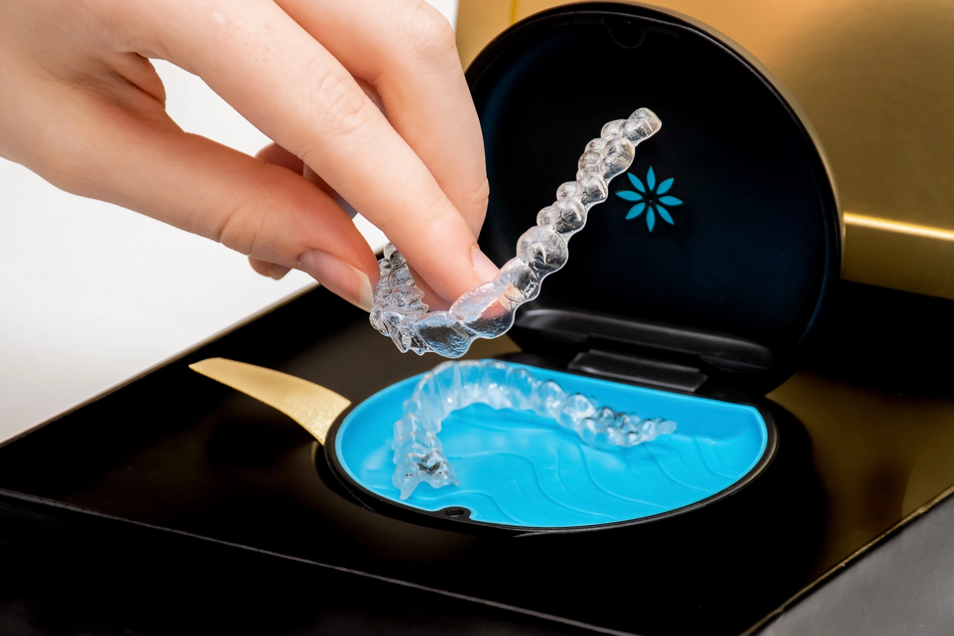 a hand holding clear plastic retainer