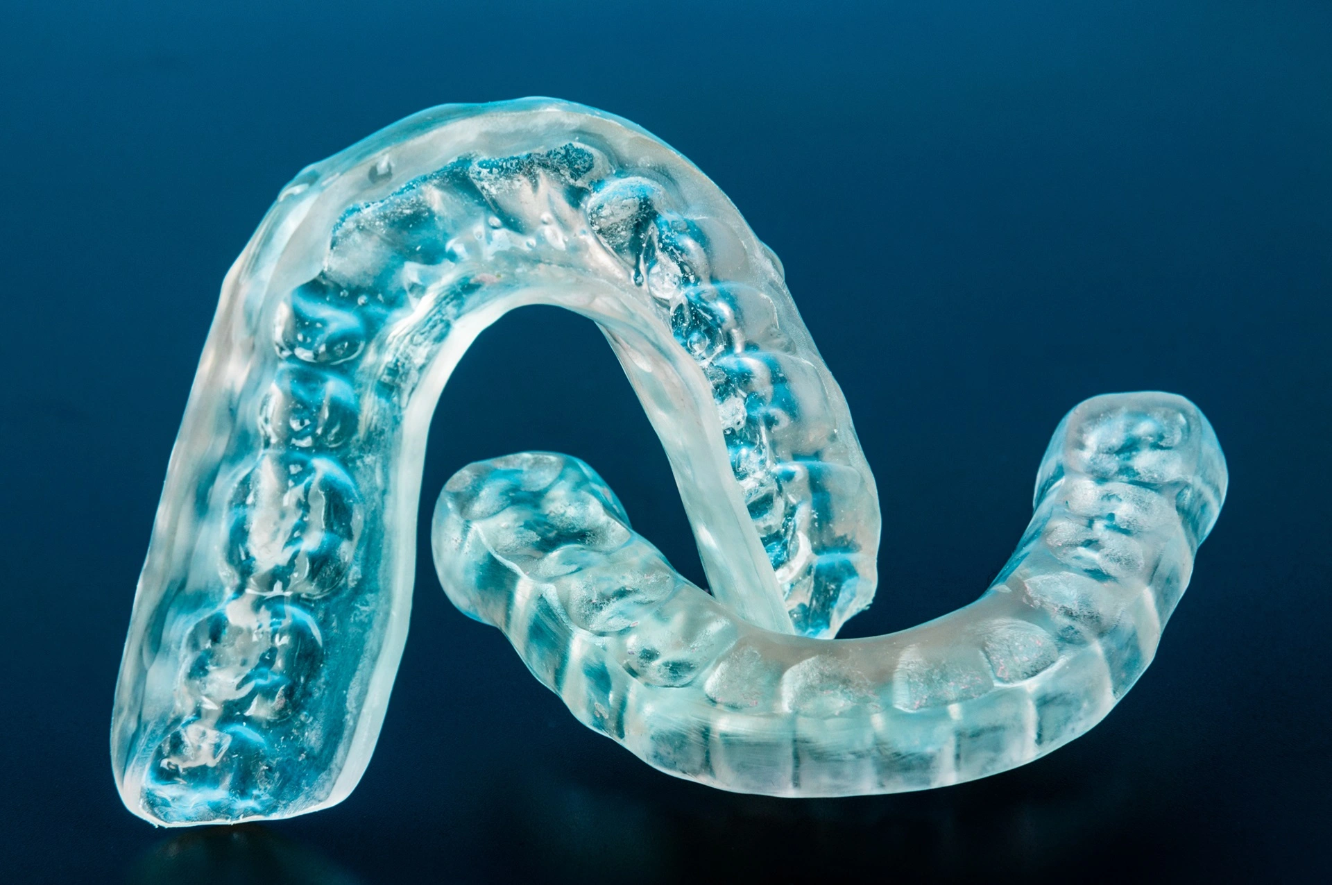 a clear plastic retainer on a blue background