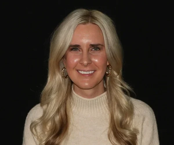 a woman with long blonde hair smiling