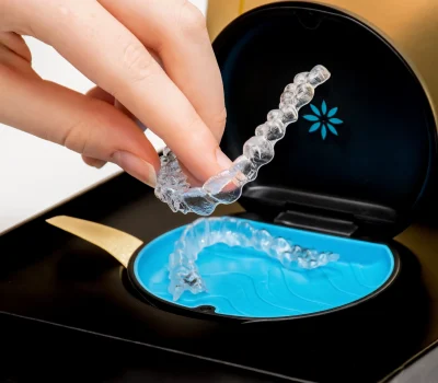 a hand holding clear plastic retainer