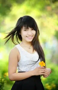 a woman holding a flower