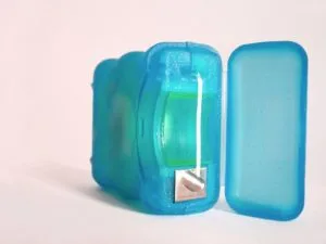 a blue plastic container with a metal object in it
